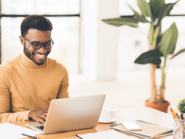 Headshot of handsome black guy using laptop Headshot of handsome black guy using laptop