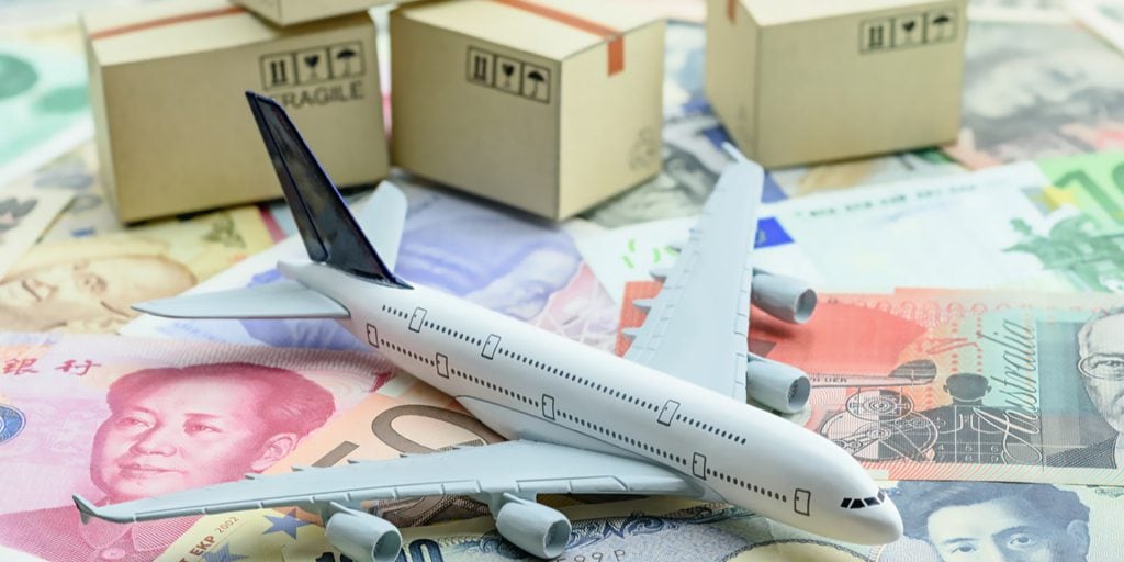 An Airplane On Top Of Money With Boxes In The Background Indicating Cross Border Shipping - Cedric Millar Tech Enabled Supply Chain Company Canada