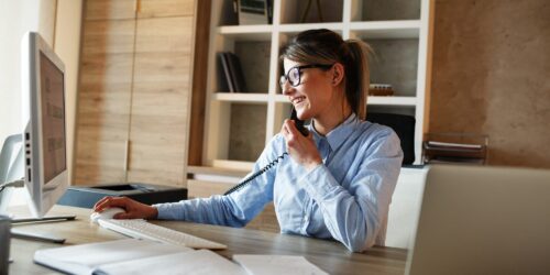 Businesswoman in her office.She sitting at the desk and talking on the phone. Businesswoman in her office.She sitting at the desk and talking on the phone.